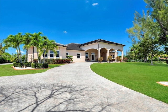 4800 SW 141st Ave, Miramar, FL 33027 - mediterranean / spanish-style home with curved driveway, stucco siding, and a front lawn