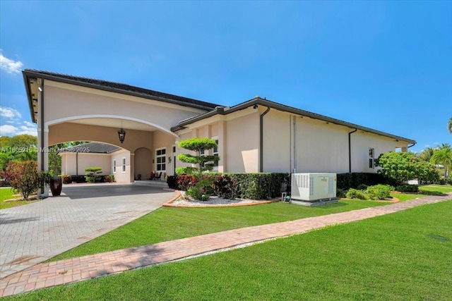 4800 SW 141st Ave, Miramar, FL 33027 - view of side of property with decorative driveway, a yard, and stucco siding