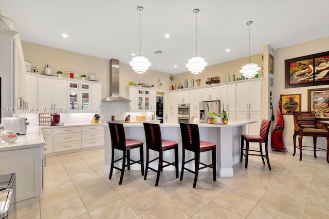 4800 SW 141st Ave, Miramar, FL 33027 - kitchen featuring appliances with stainless steel finishes, wall chimney exhaust hood, light countertops, backsplash, and white cabinetry