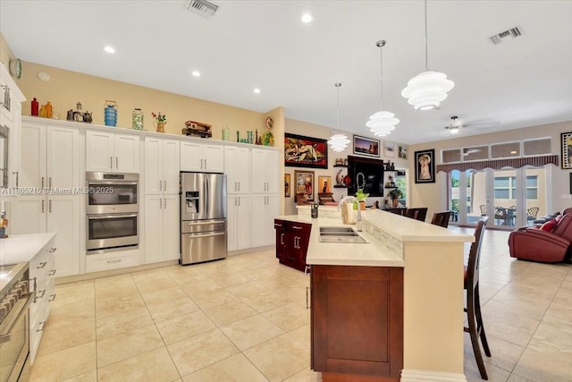 4800 SW 141st Ave, Miramar, FL 33027 - kitchen with stainless steel appliances, a sink, open floor plan, a breakfast bar area, and light tile patterned floors