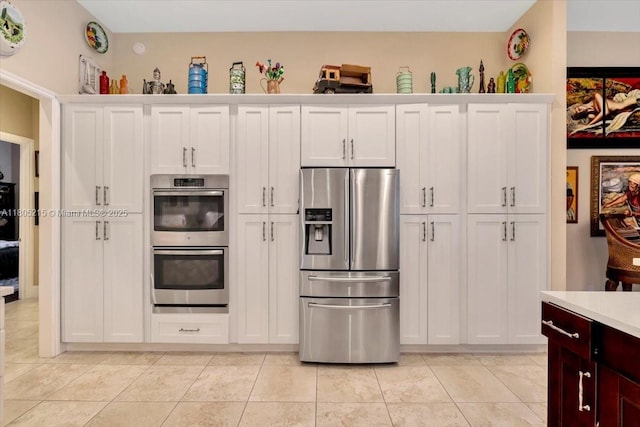 4800 SW 141st Ave, Miramar, FL 33027 - kitchen with stainless steel appliances, light countertops, white cabinetry, and light tile patterned flooring