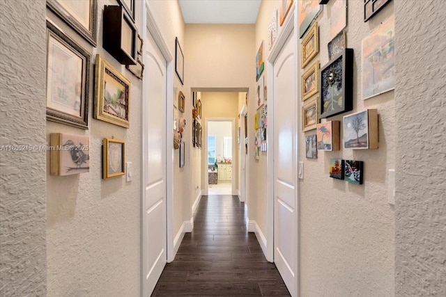 4800 SW 141st Ave, Miramar, FL 33027 - hallway with dark wood finished floors, a textured wall, and baseboards