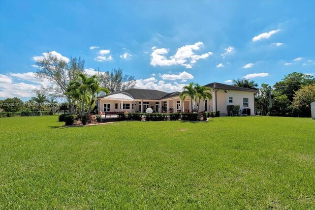 4800 SW 141st Ave, Miramar, FL 33027 - rear view of property with a lawn