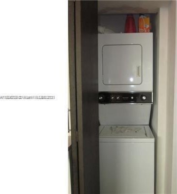 1242 Drexel Ave Unit 103, Miami Beach, FL 33139 - laundry room featuring stacked washer / dryer