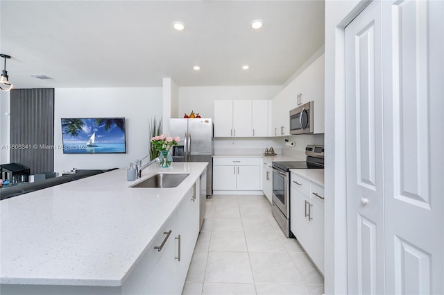 26480 SW 148th Ct Unit 26480, Homestead, FL 33032 - kitchen with stainless steel appliances, a sink, light tile patterned floors, a center island with sink, and white cabinets