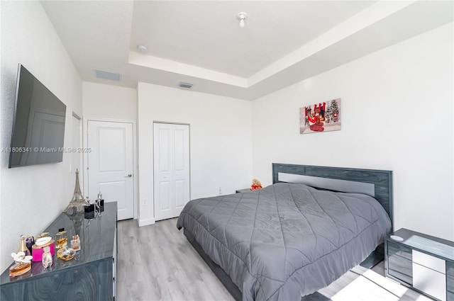26480 SW 148th Ct Unit 26480, Homestead, FL 33032 - bedroom featuring light wood-style flooring, a tray ceiling, and a closet