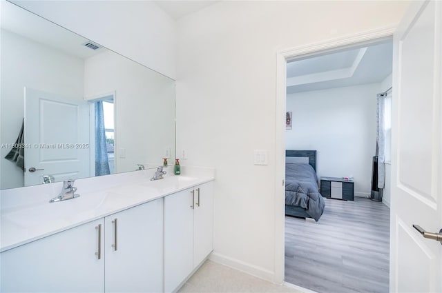 26480 SW 148th Ct Unit 26480, Homestead, FL 33032 - bathroom with baseboards, double vanity, ensuite bathroom, and wood finished floors