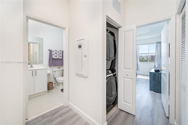 26480 SW 148th Ct Unit 26480, Homestead, FL 33032 - hall with stacked washing machine and dryer, light wood-type flooring, and baseboards