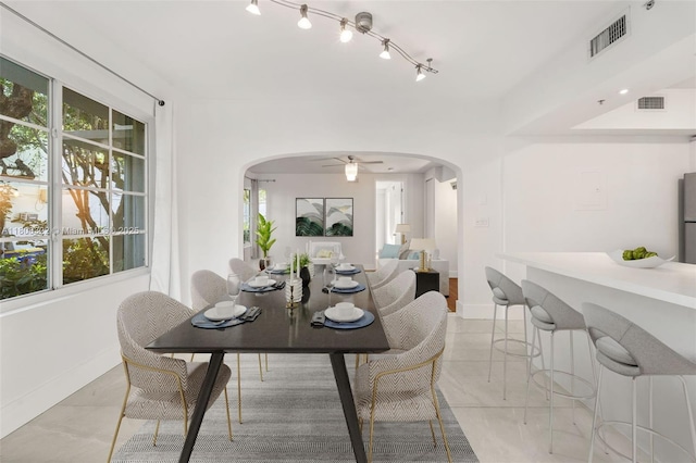 1025 Michigan Ave Unit 1C, Miami Beach, FL 33139 - dining room with arched walkways, baseboards, and a ceiling fan