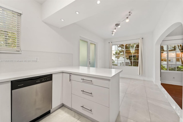 1025 Michigan Ave Unit 1C, Miami Beach, FL 33139 - kitchen with stainless steel dishwasher, a peninsula, light countertops, arched walkways, and recessed lighting