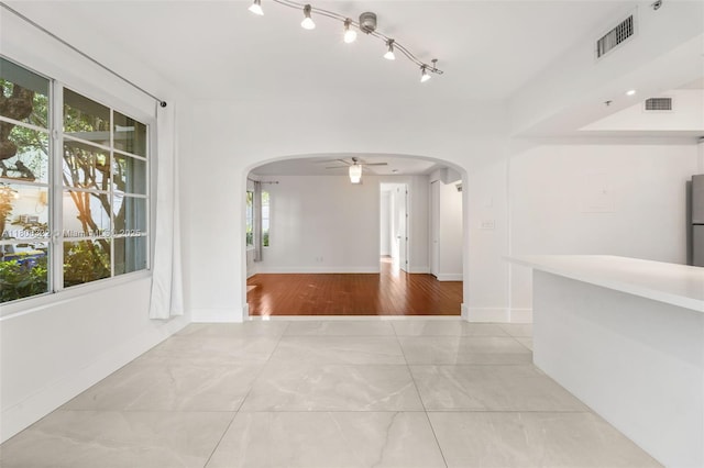 1025 Michigan Ave Unit 1C, Miami Beach, FL 33139 - spare room featuring arched walkways, ceiling fan, baseboards, and fire sprinkler in ceiling