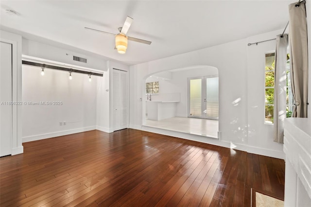 1025 Michigan Ave Unit 1C, Miami Beach, FL 33139 - unfurnished living room with baseboards, hardwood / wood-style flooring, arched walkways, and a ceiling fan