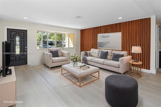 1415 Coolidge St, Hollywood, FL 33020 - living room with light wood-style floors, recessed lighting, baseboards, and an accent wall