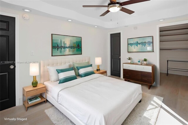 1415 Coolidge St, Hollywood, FL 33020 - bedroom with light wood-style floors, recessed lighting, ceiling fan, and a tray ceiling