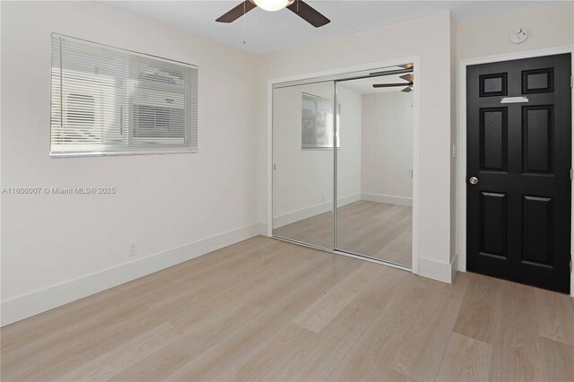 1415 Coolidge St, Hollywood, FL 33020 - unfurnished bedroom featuring light wood-type flooring, baseboards, a closet, and multiple windows