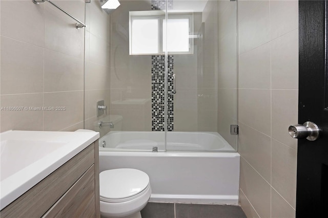 1415 Coolidge St, Hollywood, FL 33020 - full bath featuring tile walls, bath / shower combo with glass door, vanity, and toilet
