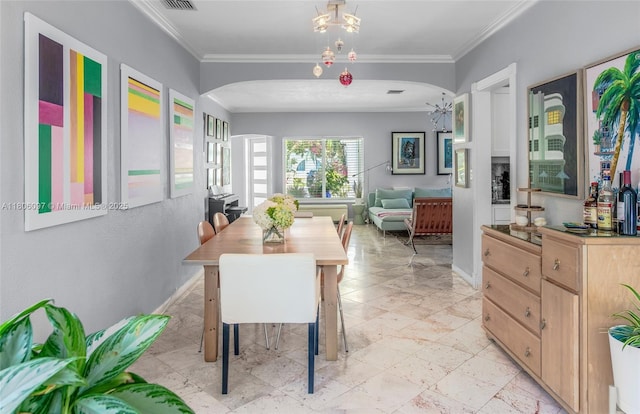 9057 Emerson Ave, Surfside, FL 33154 - dining space with arched walkways, ornamental molding, and baseboards
