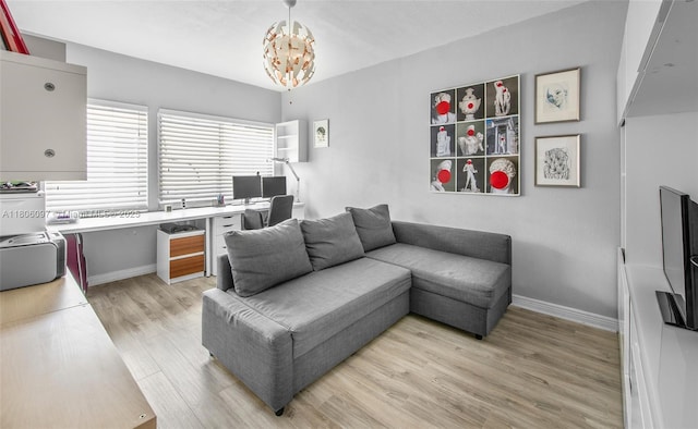 9057 Emerson Ave, Surfside, FL 33154 - living area featuring baseboards, light wood-type flooring, a chandelier, and a desk