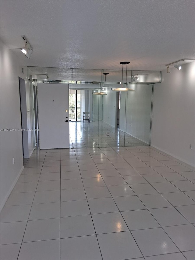 1400 Saint Charles Pl Unit 516, Pembroke Pines, FL 33026 - tiled spare room featuring baseboards and a textured ceiling