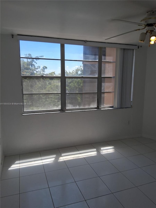 1400 Saint Charles Pl Unit 516, Pembroke Pines, FL 33026 - empty room featuring plenty of natural light, a ceiling fan, tile patterned floors, and baseboards