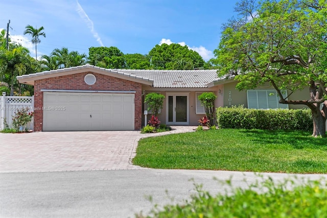 2101 NE 54th Ct, Fort Lauderdale, FL 33308 - ranch-style house featuring a tiled roof, decorative driveway, and an attached garage