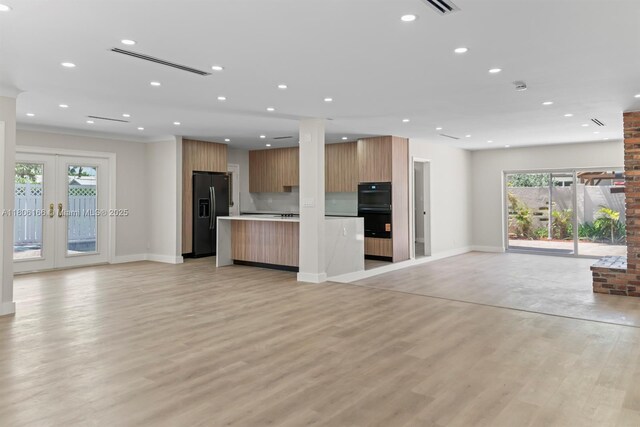 2101 NE 54th Ct, Fort Lauderdale, FL 33308 - unfurnished living room featuring recessed lighting, light wood-type flooring, baseboards, french doors, and a fireplace