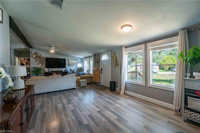 4018 Caloosa Loop, La Belle, FL 33935 - living area featuring a textured ceiling, wood finished floors, ceiling fan, vaulted ceiling, and baseboards