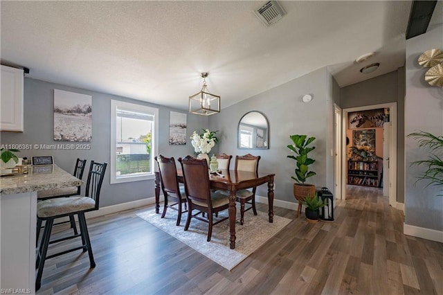4018 Caloosa Loop, La Belle, FL 33935 - dining area featuring a chandelier, wood finished floors, and baseboards