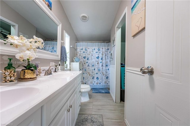 4018 Caloosa Loop, La Belle, FL 33935 - full bathroom with toilet, double vanity, a shower with curtain, and wood finished floors