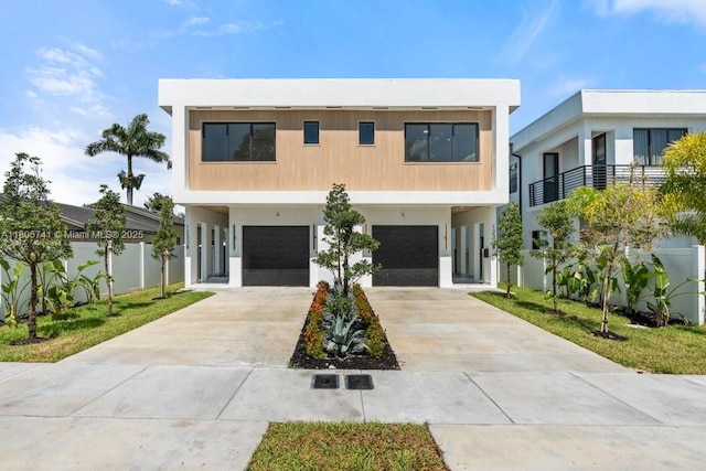 1233 NE 12th Ave Unit B, Fort Lauderdale, FL 33304 - modern home featuring a garage, concrete driveway, stucco siding, and a carport