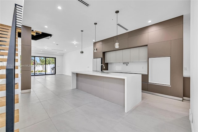 1233 NE 12th Ave Unit B, Fort Lauderdale, FL 33304 - kitchen with freestanding refrigerator, modern cabinets, light countertops, recessed lighting, and a large island
