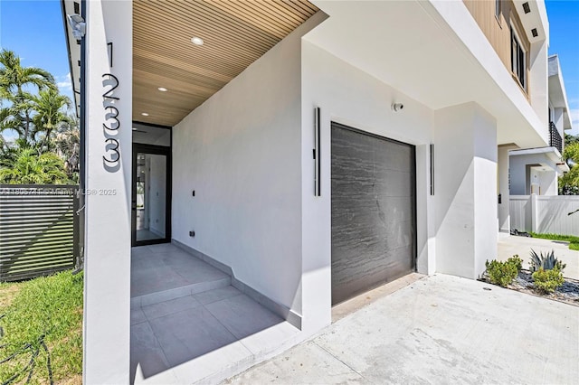 1233 NE 12th Ave Unit B, Fort Lauderdale, FL 33304 - view of exterior entry featuring stucco siding and driveway
