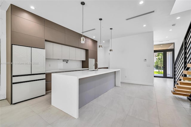 1233 NE 12th Ave Unit B, Fort Lauderdale, FL 33304 - kitchen with modern cabinets, light countertops, recessed lighting, pendant lighting, and a center island with sink