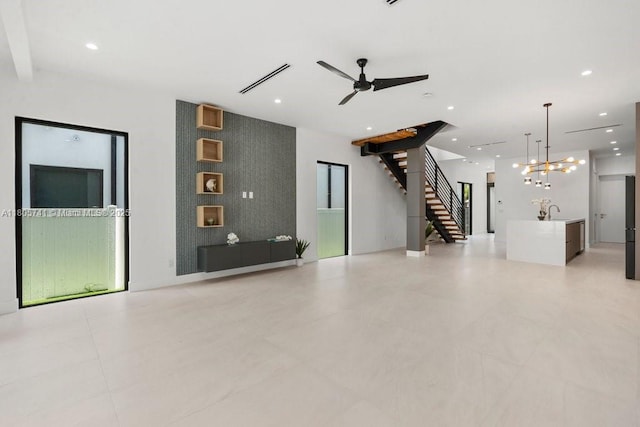1233 NE 12th Ave Unit B, Fort Lauderdale, FL 33304 - unfurnished living room with stairway, a chandelier, a ceiling fan, and recessed lighting