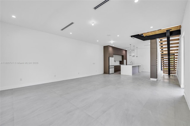 1233 NE 12th Ave Unit B, Fort Lauderdale, FL 33304 - unfurnished living room with recessed lighting and stairway