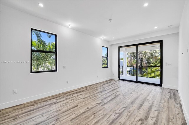 1233 NE 12th Ave Unit B, Fort Lauderdale, FL 33304 - spare room featuring plenty of natural light, light wood-type flooring, recessed lighting, and fire sprinkler in ceiling