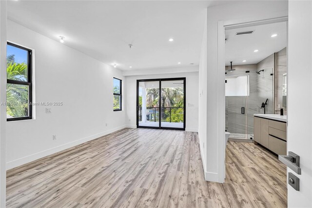 1233 NE 12th Ave Unit B, Fort Lauderdale, FL 33304 - unfurnished bedroom featuring light wood-style flooring, an accent wall, recessed lighting, and a ceiling fan