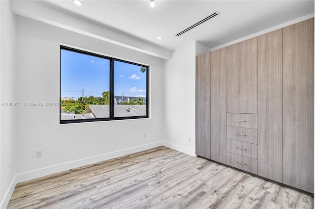 1233 NE 12th Ave Unit B, Fort Lauderdale, FL 33304 - unfurnished bedroom with light wood-style floors and recessed lighting