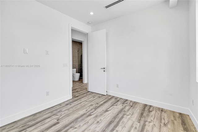 1233 NE 12th Ave Unit B, Fort Lauderdale, FL 33304 - empty room featuring light wood finished floors, recessed lighting, and a smoke detector