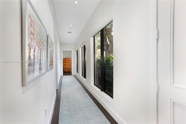 hallway featuring baseboards and recessed lighting