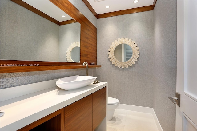 bathroom with toilet, vanity, ornamental molding, and recessed lighting
