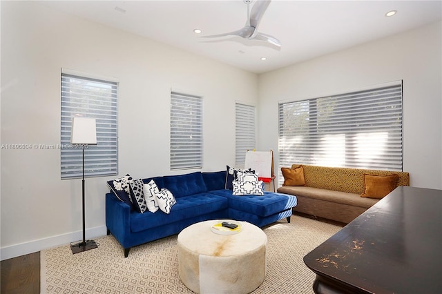 living area with a ceiling fan, recessed lighting, baseboards, and light colored carpet