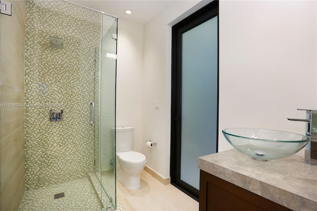 full bathroom featuring toilet, a shower stall, vanity, and recessed lighting