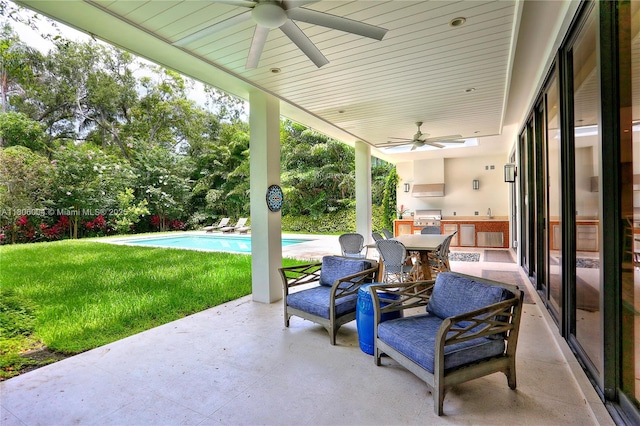 view of patio / terrace with ceiling fan and an outdoor pool