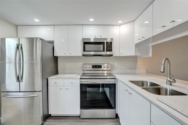 1108 Bahama Bnd Unit B1, Coconut Creek, FL 33066 - kitchen featuring appliances with stainless steel finishes, a sink, white cabinetry, light countertops, and recessed lighting