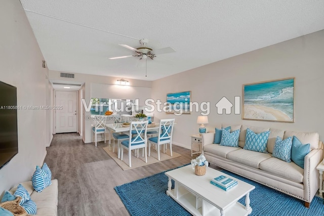 1108 Bahama Bnd Unit B1, Coconut Creek, FL 33066 - living area with wood finished floors, ceiling fan, a textured ceiling, and baseboards