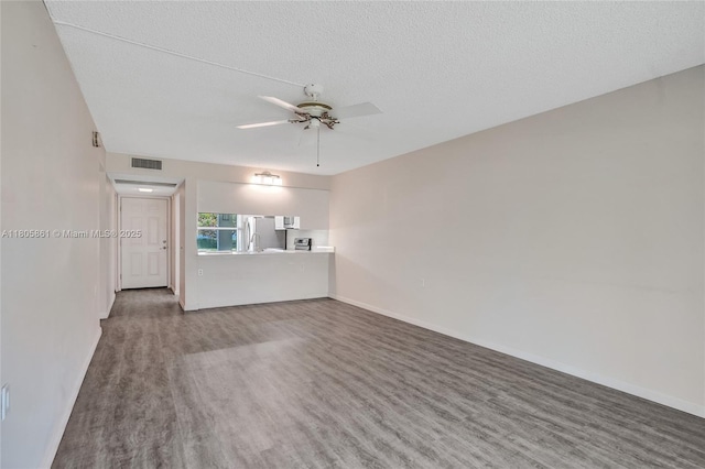 1108 Bahama Bnd Unit B1, Coconut Creek, FL 33066 - unfurnished living room with a ceiling fan, wood finished floors, a textured ceiling, and baseboards
