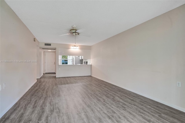 1108 Bahama Bnd Unit B1, Coconut Creek, FL 33066 - unfurnished living room with wood finished floors, a ceiling fan, and baseboards