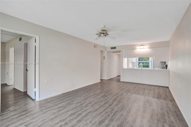 1108 Bahama Bnd Unit B1, Coconut Creek, FL 33066 - spare room with wood finished floors, ceiling fan, a textured ceiling, and baseboards