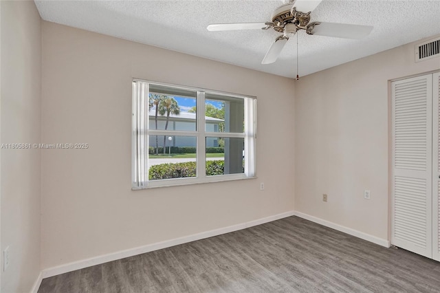 1108 Bahama Bnd Unit B1, Coconut Creek, FL 33066 - unfurnished bedroom featuring wood finished floors, a closet, a textured ceiling, baseboards, and a ceiling fan
